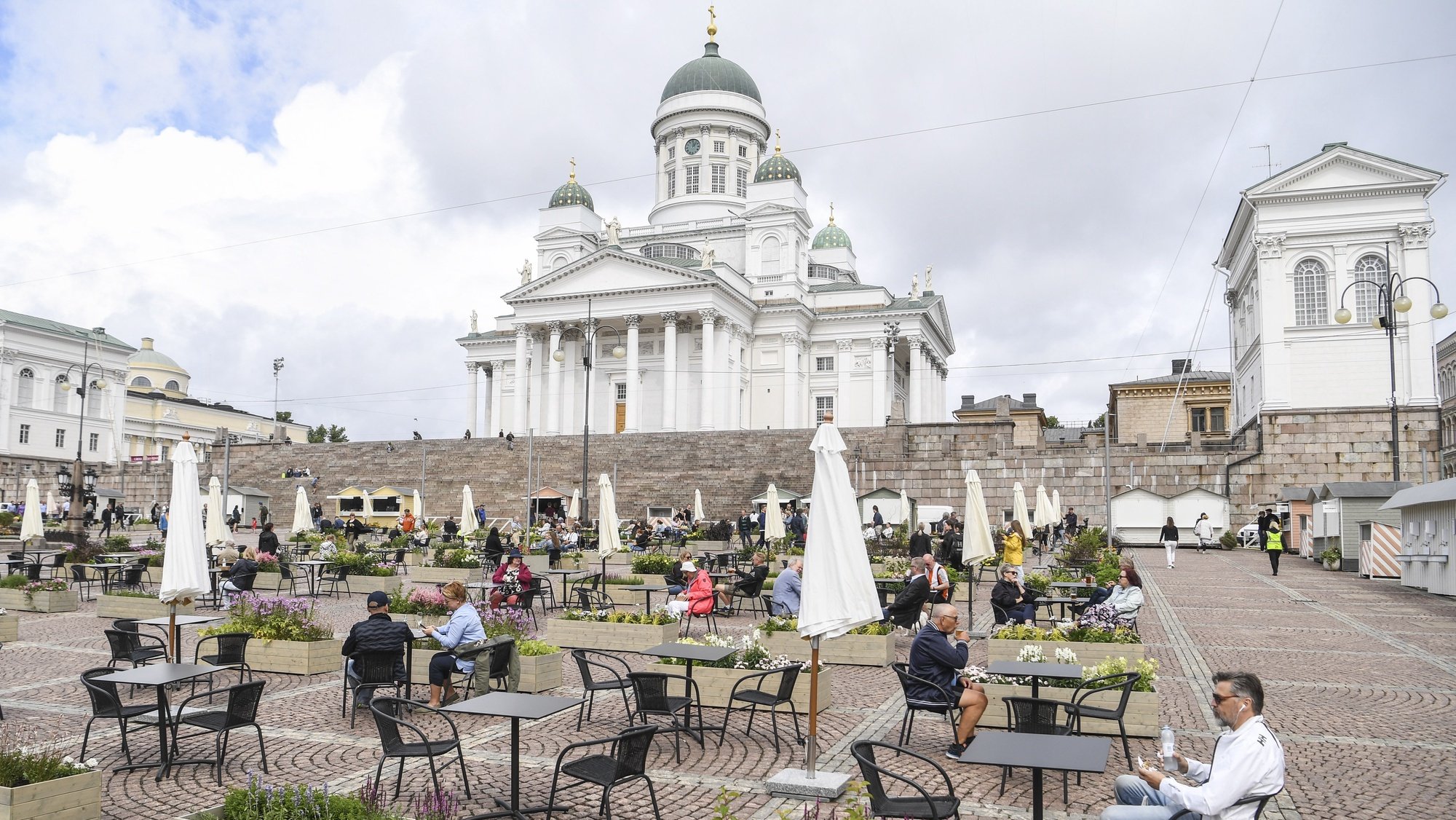 epaselect epa08520247 People sit on the Super Terrace that has been opened at Senate Square in Helsinki, Finland, 01 July 2020. It provides seating for 480 people and a number of pop-up restaurants to be introduced to the square as a means of allowing safer dining in the age of COVID-19. The terrace is open until the end of August 2020.  EPA/KIMMO BRANDT
