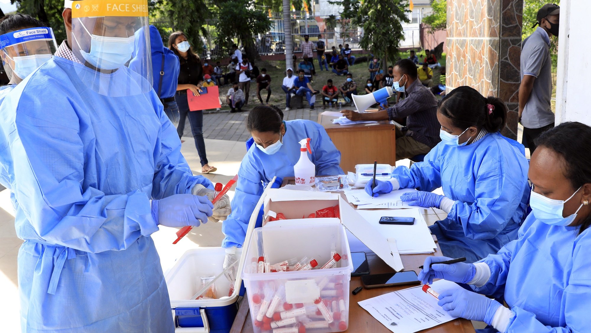 epa09226181 Health workers collect specimen samples during a COVID-19 swab test drive in Dili, East Timor, also known as Timor Leste, 25 May 2021. East Timor has recorded nearly 6,000 COVID-19 cases since the beginning of the pandemic.  EPA/ANTONIO DASIPARU