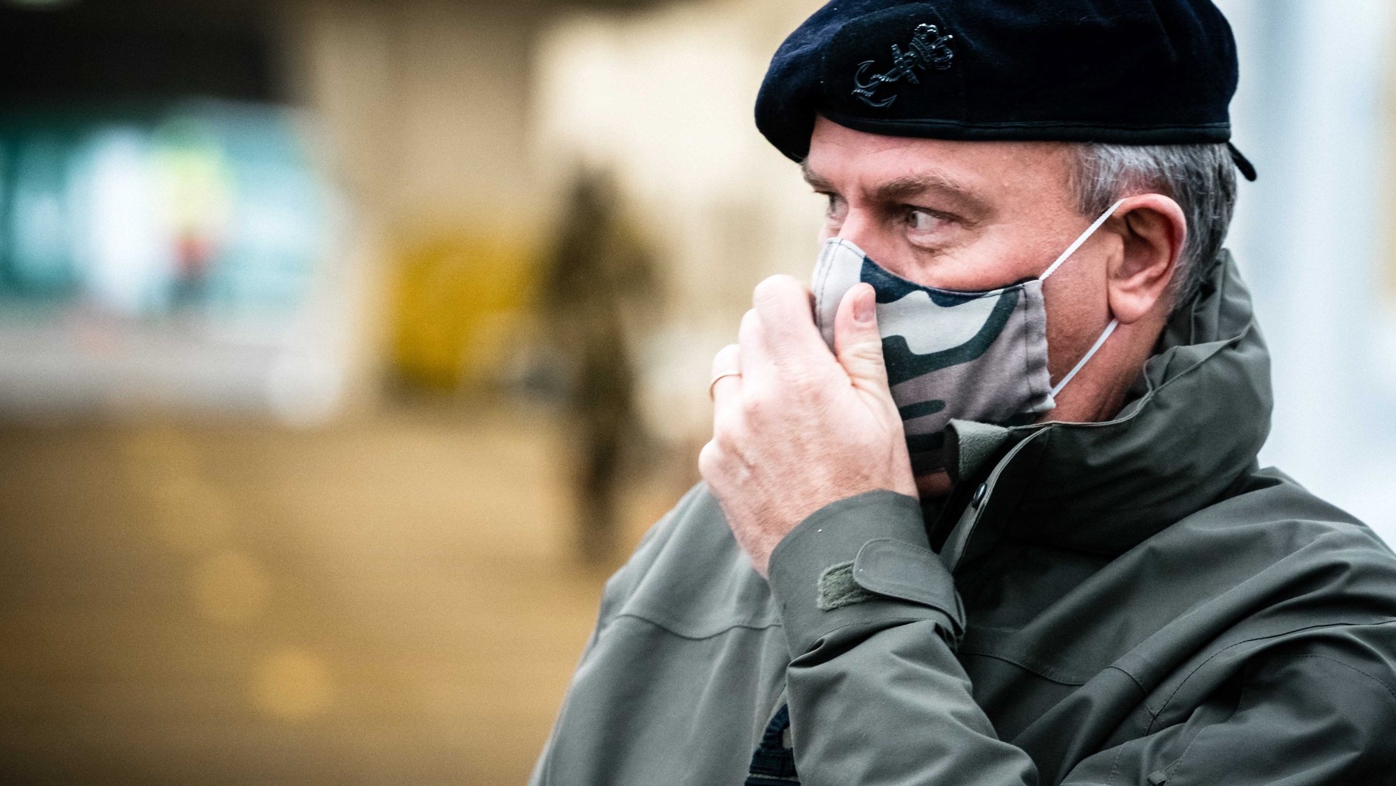 epa08856688 Commander of the Dutch Armed Forces Rob Bauer looks on at the XL test street in Eindhoven, Netherlands, 02 December 2020. Soldiers from the base in Oirschot offered their assistance in carrying out corona tests at the facility.  EPA/ROB ENGELAAR
