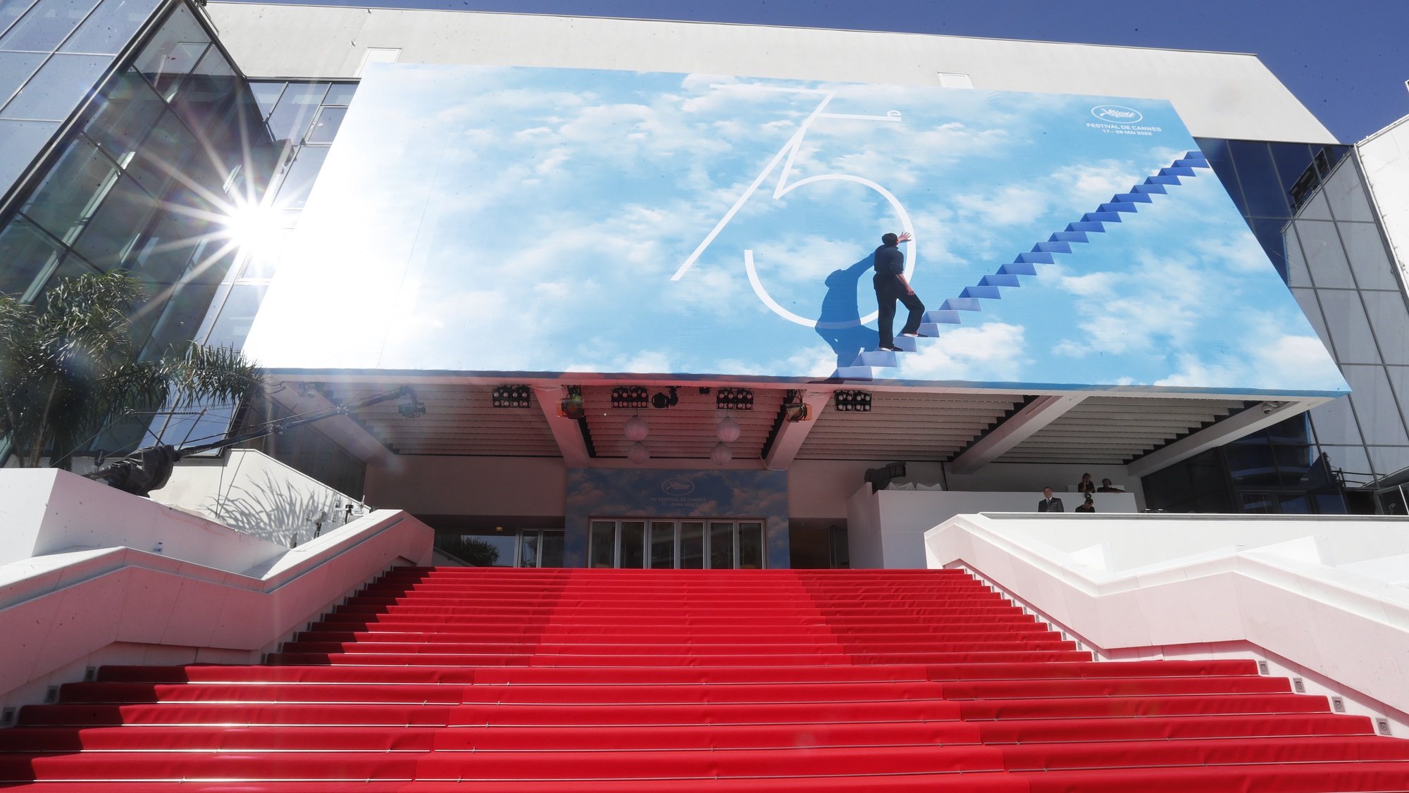 epa09952240 Workers assemble the red carpet ahead of the 75th annual Cannes Film Festival, in Cannes, France, 17 May 2022. The festival runs from 17 to 28 May.  EPA/GUILLAUME HORCAJUELO