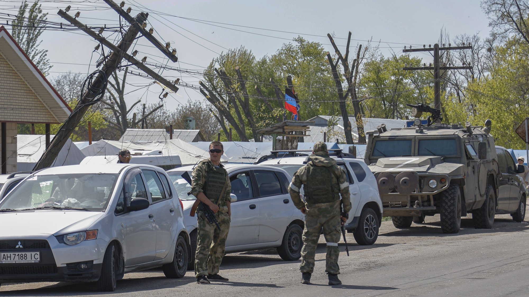 epa09932615 Russian servicemen stand guard at the temporary accommodation center for people was evacuated from Azovstal, in Bezimenoye village near Mariupol, Ukraine, 07 May 2022. According to the Interdepartmental Coordinating Headquarters of the Russian Federation for Humanitarian Response, 51 civilians, including 11 children, were evacuated from the Azovstal plant between 05 and 07 May. On 24 February, Russian troops had entered Ukrainian territory in what the Russian president declared a &#039;special military operation&#039;, resulting in fighting and destruction in the country. According to data released by the United Nations High Commission for the Refugees (UNHCR) on 05 May, over 5.7 million refugees have fled Ukraine seeking safety, protection and assistance in neighboring countries.  EPA/ALESSANDRO GUERRA