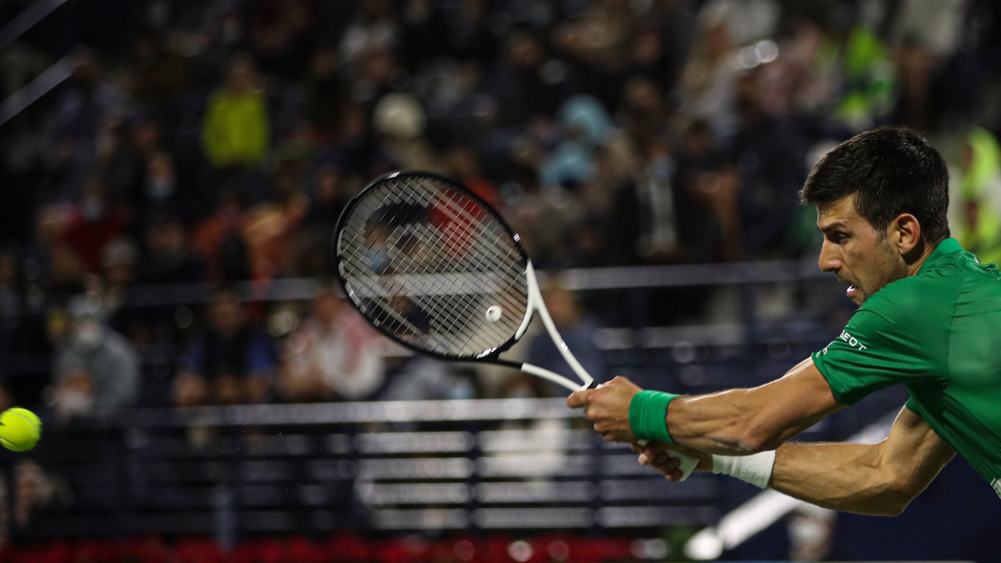 epa09776138 Novak Djokovic of Serbia in action during his first round match against Lorenzo Musetti of Italy at the Dubai Duty Free Tennis ATP Championships 2022 in Dubai, United Arab Emirates, 21 February 2022.  EPA/ALI HAIDER