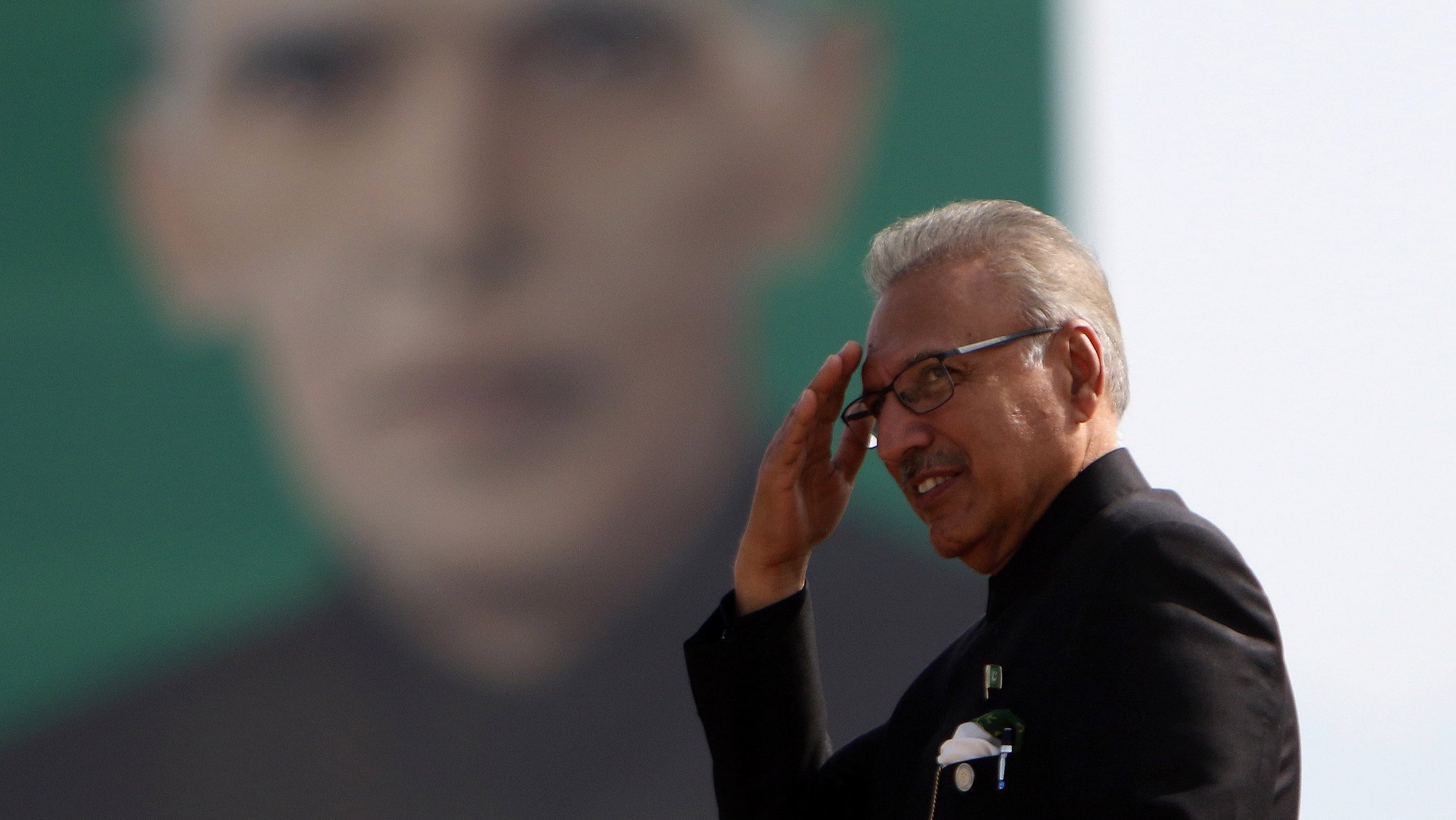 epa09106265 (FILE) Arif Alvi, President of Pakistan passes by the portrait of Muhammad Ali Jinnah, founder of Pakistan during the military parade to mark Pakistan National Day, in Islamabad, Pakistan, 25 March 2021 (reissued 30 March 2021). Pakistanâ€™s president Arif Alvi on 29 March, announced he had contracted coronavirus, two weeks after receiving the first dose of the Chinese Sinopharm vaccine as a third wave of infections hits the south Asian country. Pakistan tightened restrictions amid a fresh Covid-19 wave that is turning out to be worse than the previous two in a country battling an inordinate delay in anti-coronavirus vaccines.  EPA/SOHAIL SHAHZAD