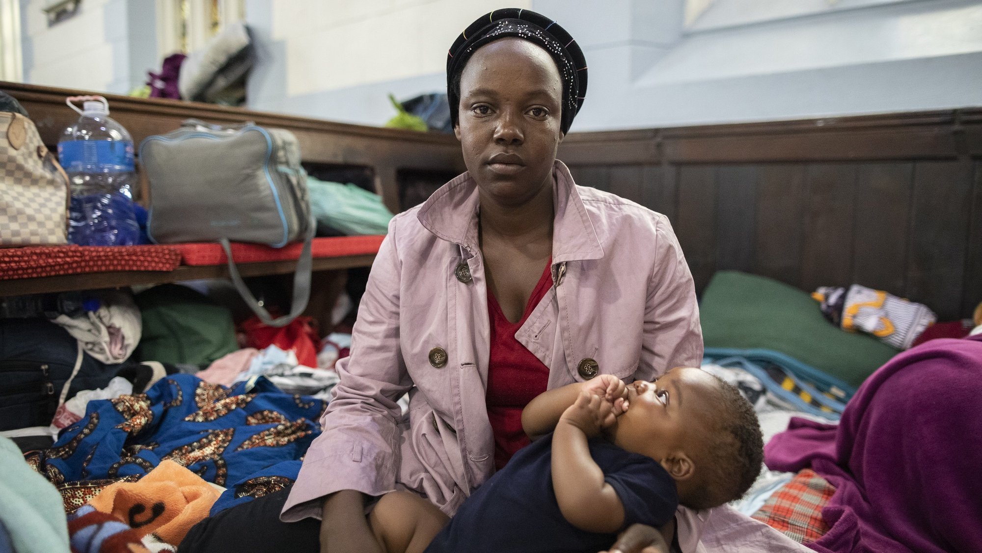 epa08026643 27 year old mother of 3 children Julie Mutosie from  the Democratic Republic of Congo (DRC) poses for a photograph inside Central Methodist Church, Cape Town, South Africa, 26 November 2019. Following weeks of taking refuge in Central Methodist Church there is still no resolution for the refugees with authorities. The hundreds of foreign nationals taking refuge inside Central Methodist Church are preparing to leave by foot for another country. Police forcefully removed the group from an office block they occupied weeks ago as part of a sit in protest at the United Nations High Commission for Refugees (UNHCR) before the group moved to the church. The Foreign Nationals site fears over xenophobic attacks and fear for their safety in South Africa with similar protests by African foreign nationals occurring in Pretoria. Community leaders complain the UNHCR is doing nothing to help them. Four teenagers who were among the group of refugees died by drowning on 24 November after they tried to have a swim at a nearby beach.  EPA/NIC BOTHMA ATTENTION: This Image is part of a PHOTO SET