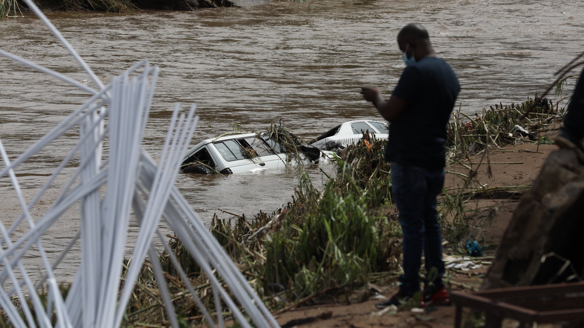 epa09886248 Two cars are submerged in flood waters near Durban, South Africa, 12 April 2022. At least 45 people have died as a result of heavy flooding in the Eastern Coastal area. Key roads in the area have been damaged and as mudslides destroyed houses. The South African National Defense Force have been called in to assist.  EPA/STR