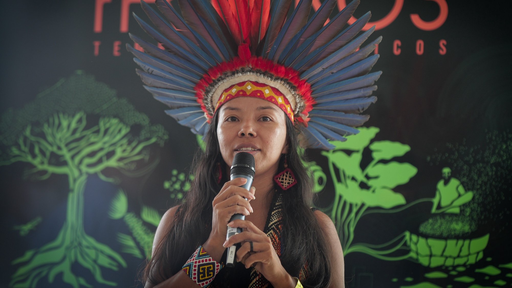 epa09646880 Indigenous Vanda Ortega, from the Witoto people, speaks during the opening of the exhibition 'Fruturos - Tempos Amazonicos' (Fruits - Amazon Times) at the Amanha Museum in Rio de Janeiro, Brazil, 16 December 2021 (issued 17 December 2021). The immensity of the Amazon, its richness, the ethnic groups that live there and their customs, are part of an exhibition in Rio de Janeiro that from 17 December on immerses the viewer in the reality of the most extensive tropical forest on the planet to highlight the urgency of its conservation. The exhibition 'Futures', which can be seen until June 2022 at the Museum of Tomorrow in Rio, brings an updated perspective of this biome and proposes new challenges to keep the forest standing.  EPA/Andre Coelho