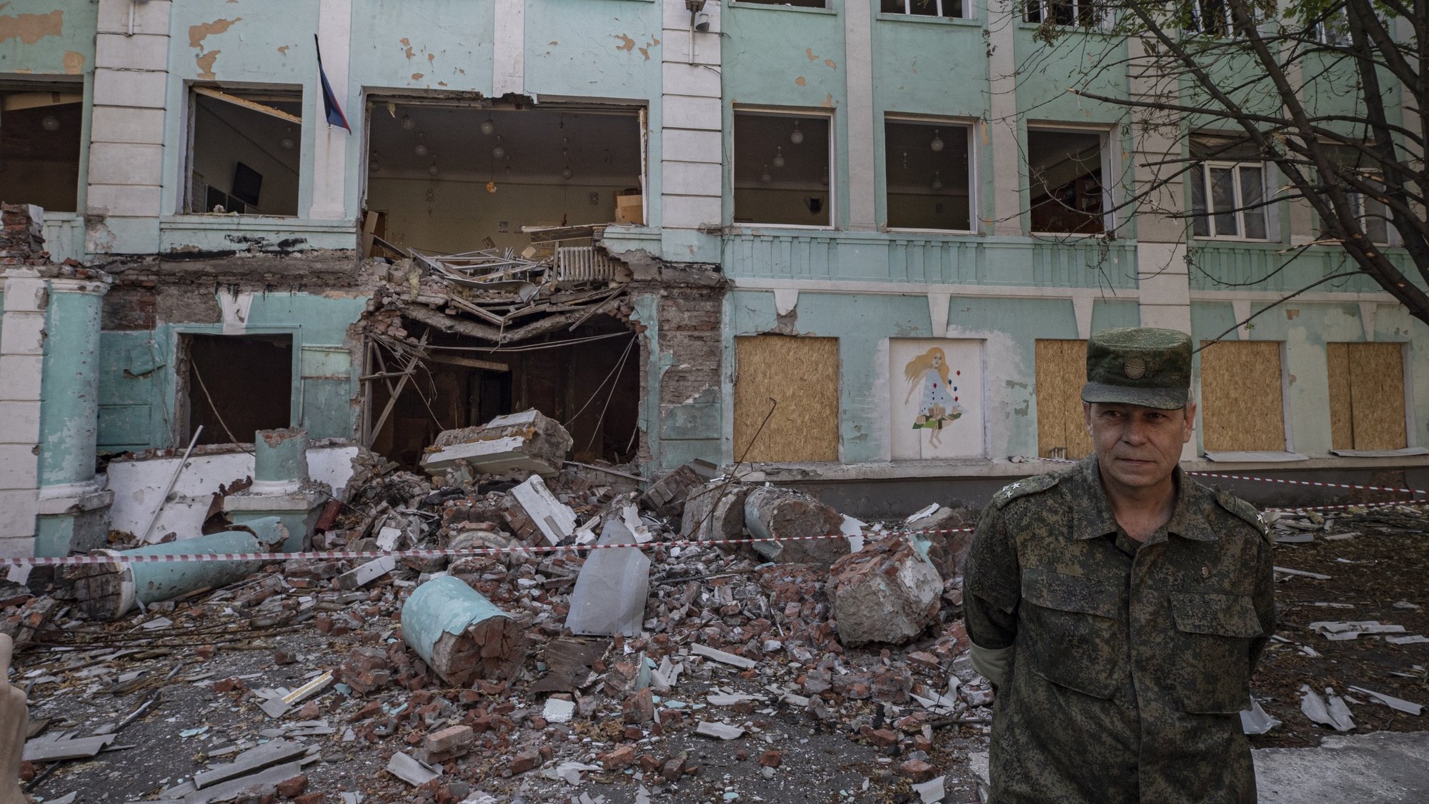 epa10011480 A picture taken during a visit to Mariupol organized by the Russian military shows Eduard Basurin, deputy head of the People&#039;s Militia Department of the self-proclaimed Donetsk People&#039;s Republic (DPR), stands in front of the school No. 22 damaged in shelling on 30 May in downtown Donetsk, Ukraine, 13 June 2022. According to Basurin, the shelling of Donetsk, including the city center, began after Western countries started to supply heavy weapons to Ukraine. On 24 February Russian troops entered Ukrainian territory starting a conflict that has provoked destruction and a humanitarian crisis.  EPA/SERGEI ILNITSKY