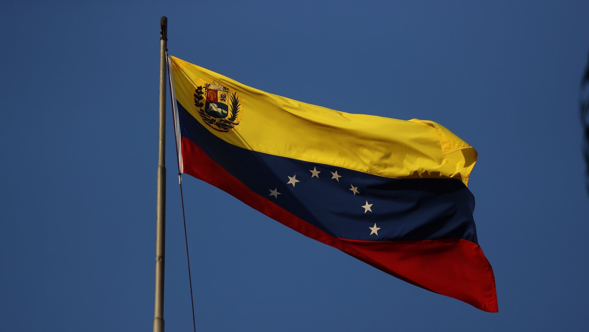 epa09688509 The Venezuelan flag before the start of the annual speech by the President of Venezuela, Nicolas Maduro in Caracas, Venezuela, 15 January 2022.  EPA/Miguel Gutierrez