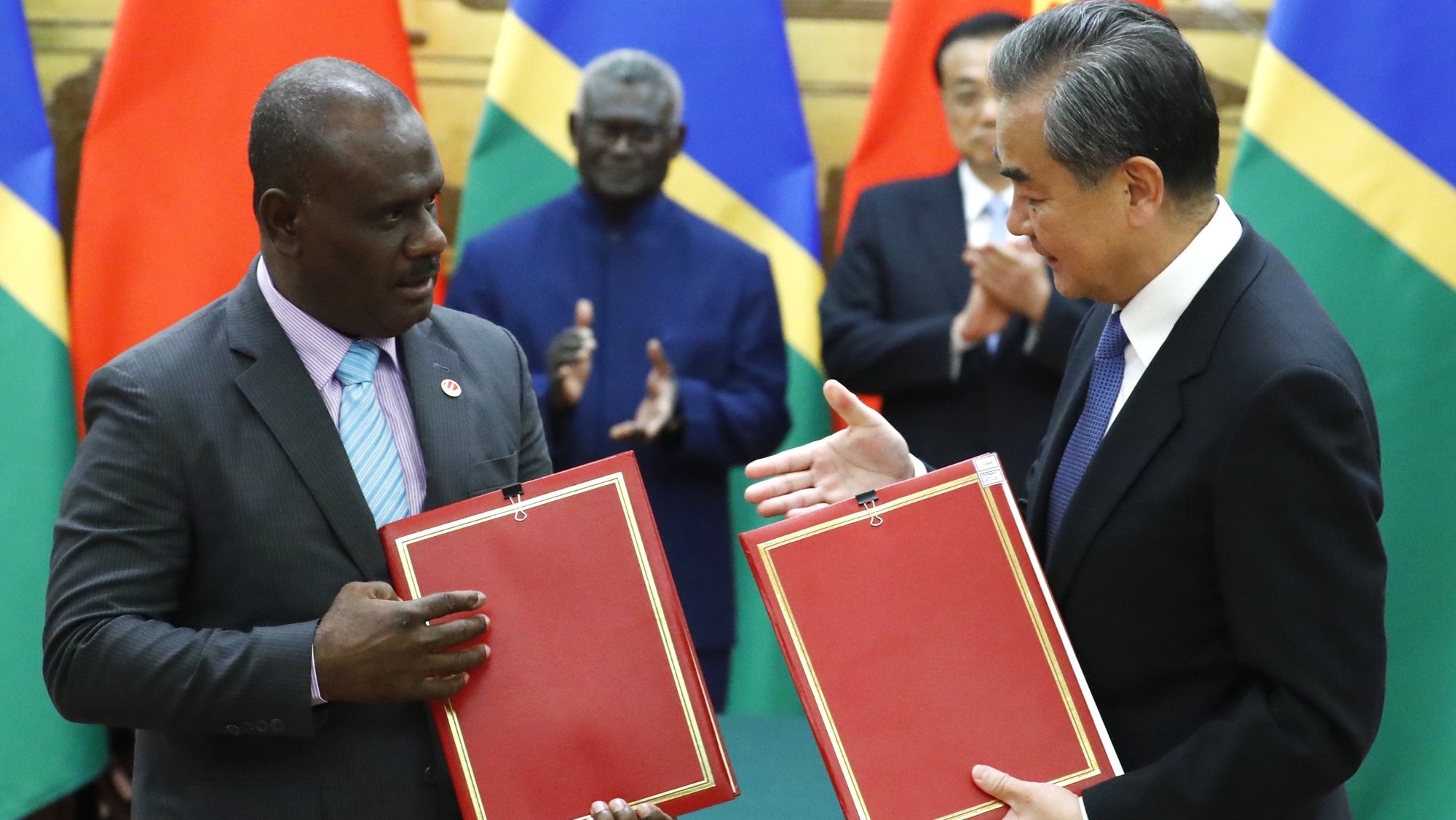 epa07906550 Chinese State Councillor and Foreign Minister Wang Yi (R) and Solomon Islands Foreign Minister Jeremiah Manele (L) attend a signing ceremony at the Great Hall of the People in Beijing, China, 09 October 2019.  EPA/THOMAS PETER / POOL