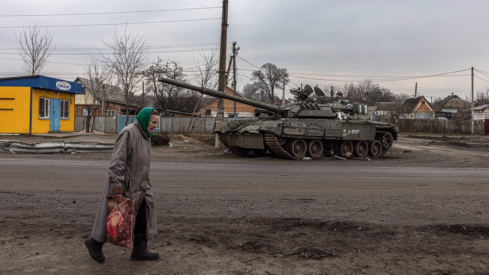 epaselect epa09861036 An elderly woman walks past a damaged Russian tank in recaptured by the Ukrainian army Trostyanets town, in Sumy region, Ukraine, 30 March 2022. Trostyanets was recaptured by the Ukrainian army after the town was under the control of Russian forces for over a month following the invasion on 24 February. The local residents claim that Russian soldiers were not letting bury the dead people, forcing many to leave their homes to move into those houses, and were looting in the town. Locals were saying that some of the town&#039;s residents were killed by Russian soldiers. When the Russian army was withdrawing from Trostyanets they stole many cars from local people, as well as different electronic devices.  EPA/ROMAN PILIPEY