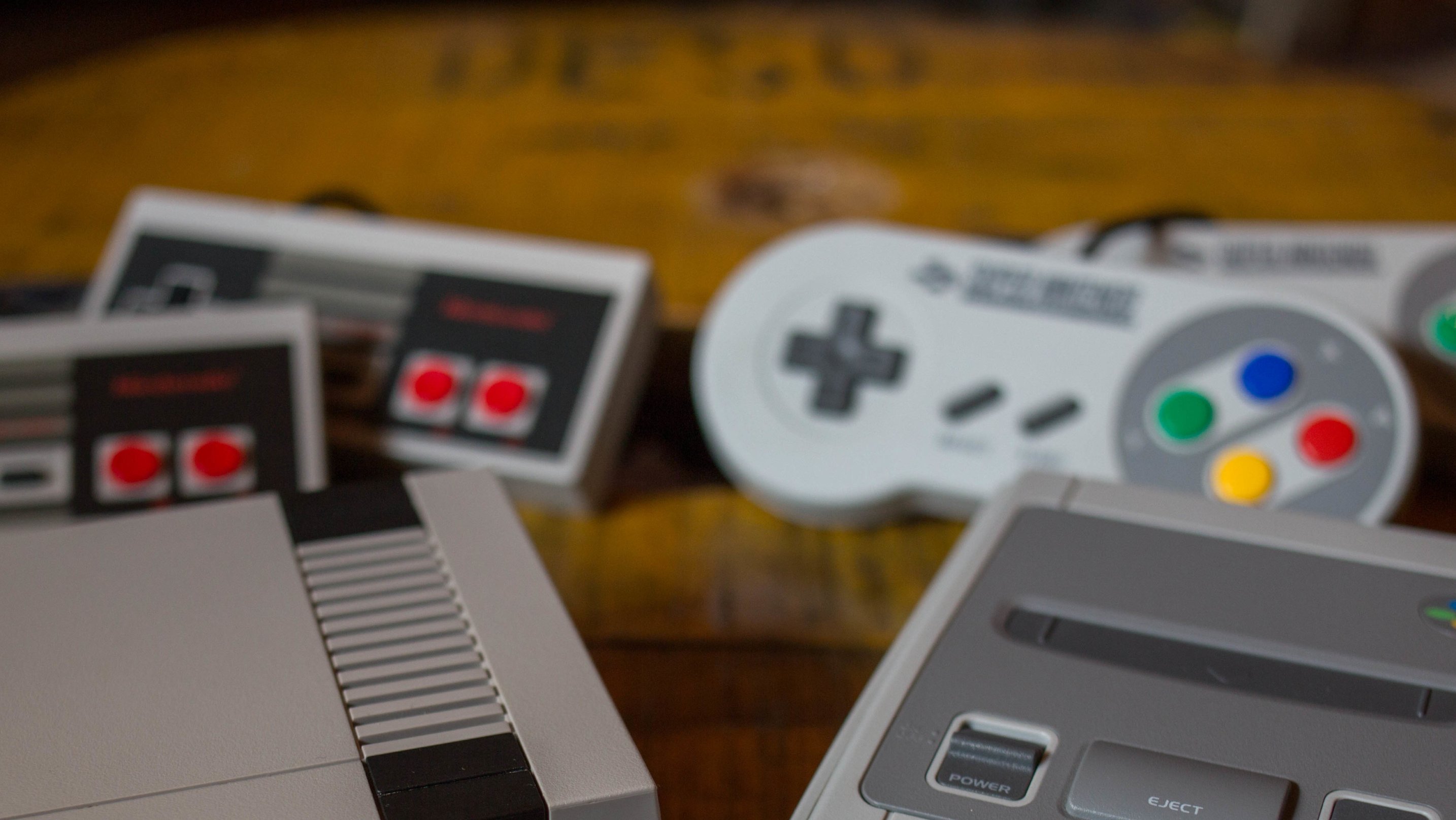 A NES (Nintendo Entertainment System) Classic Mini (L) and a