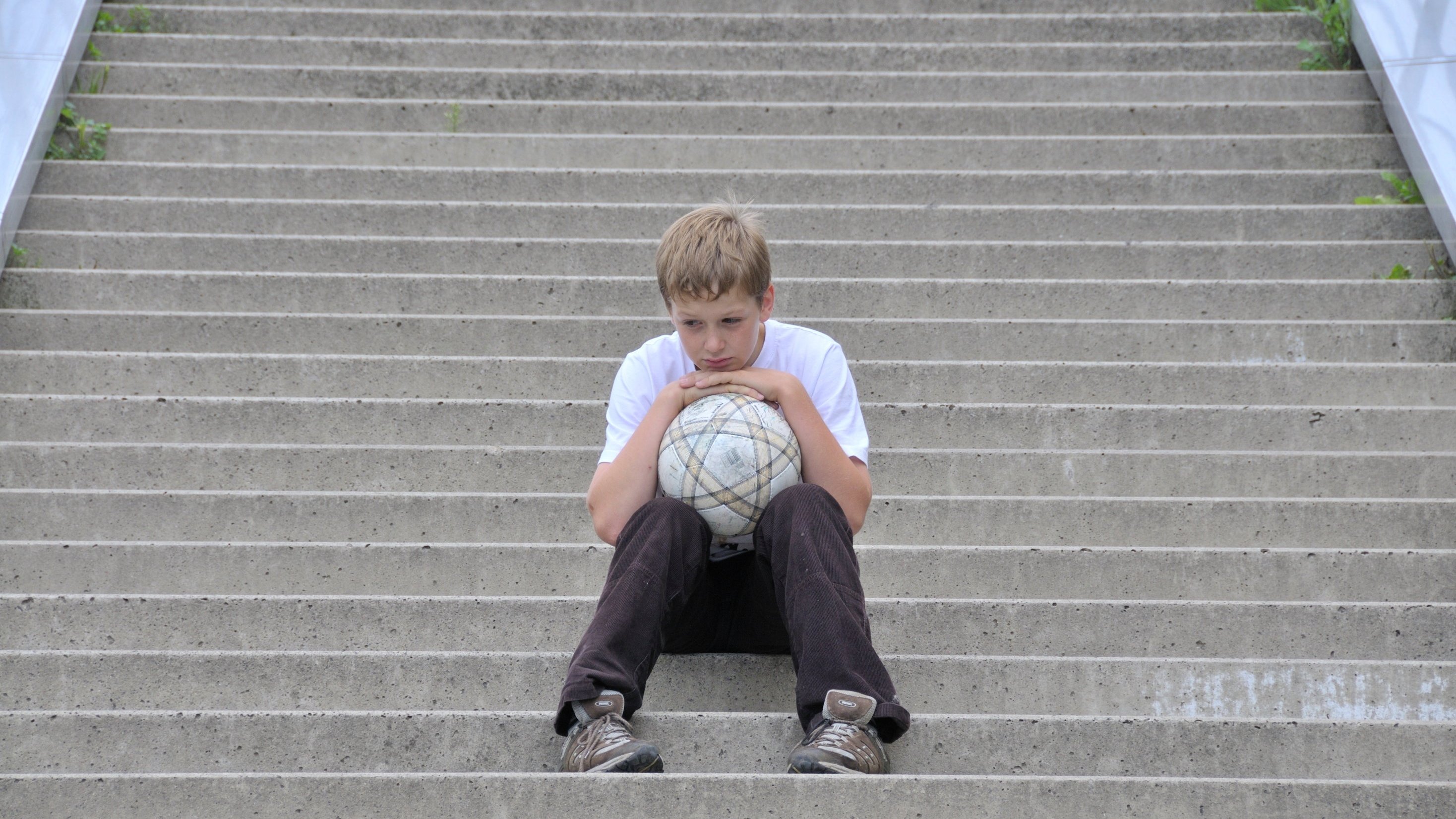 Lonesome boy with football sitting on the stairs - 28.08.2010