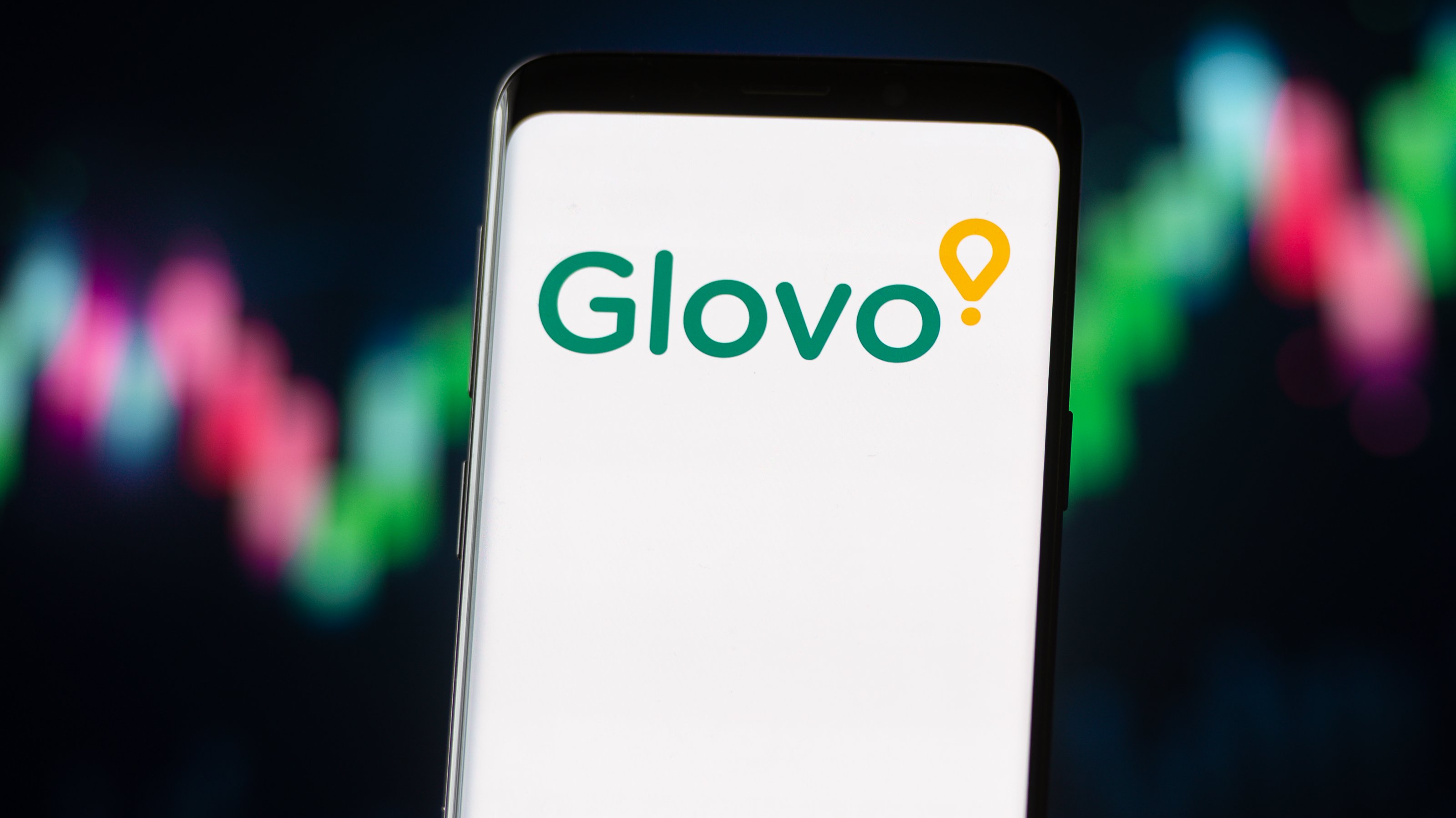 In this photo illustration a Glovo logo seen displayed on a