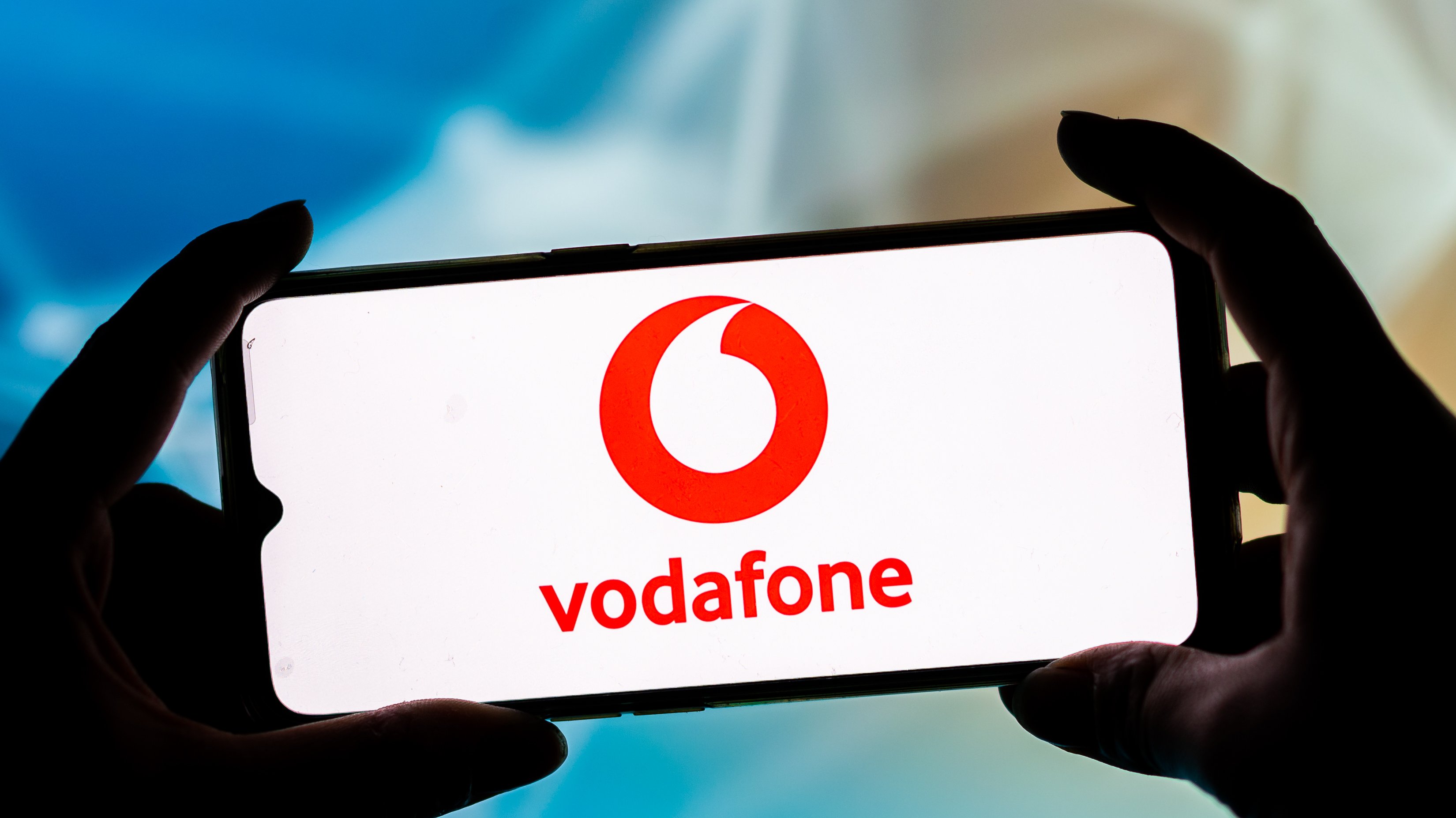 In this photo illustration a Vodafone logo seen displayed on