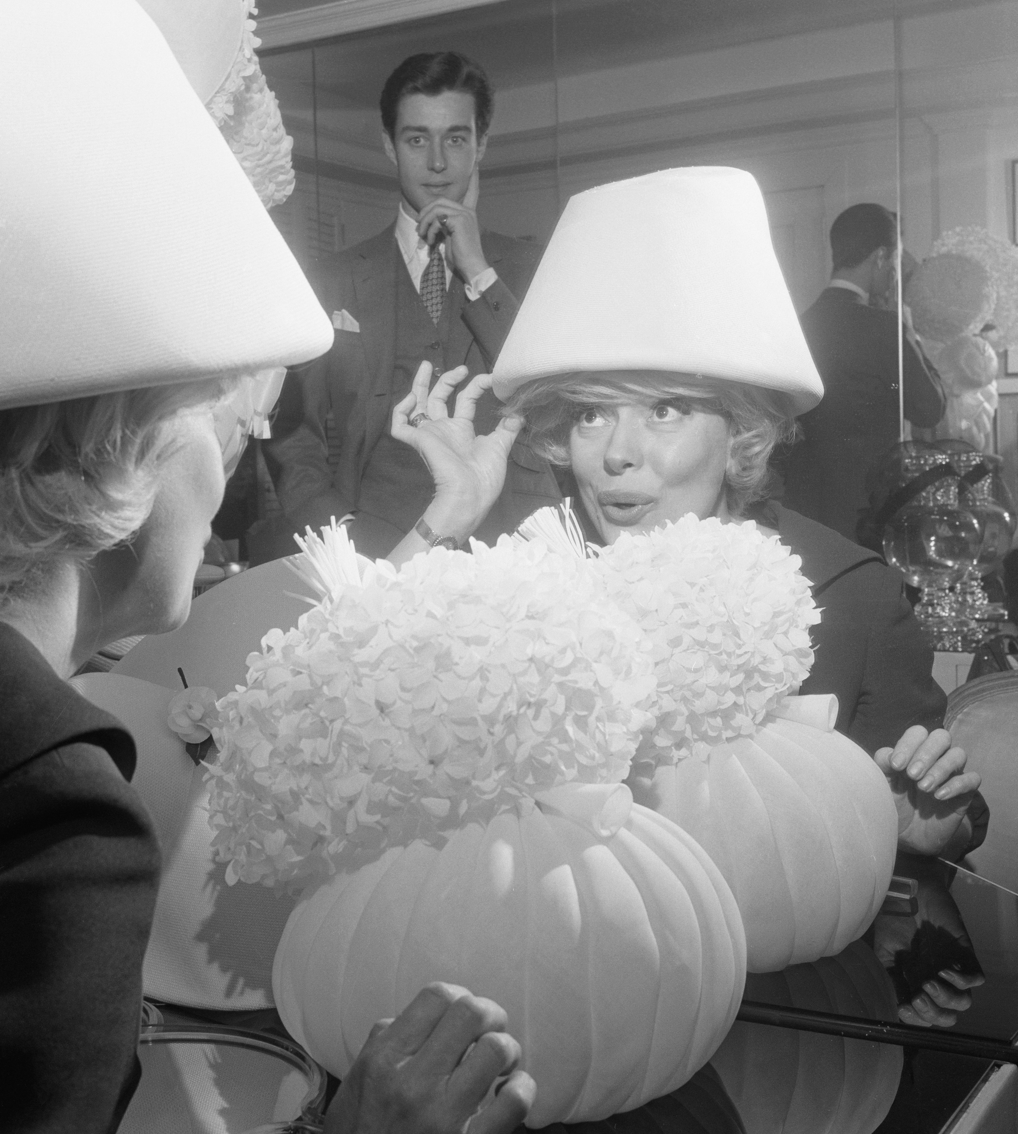 Actress Carol Channing Trying Elaborate Hat with Halston in Background