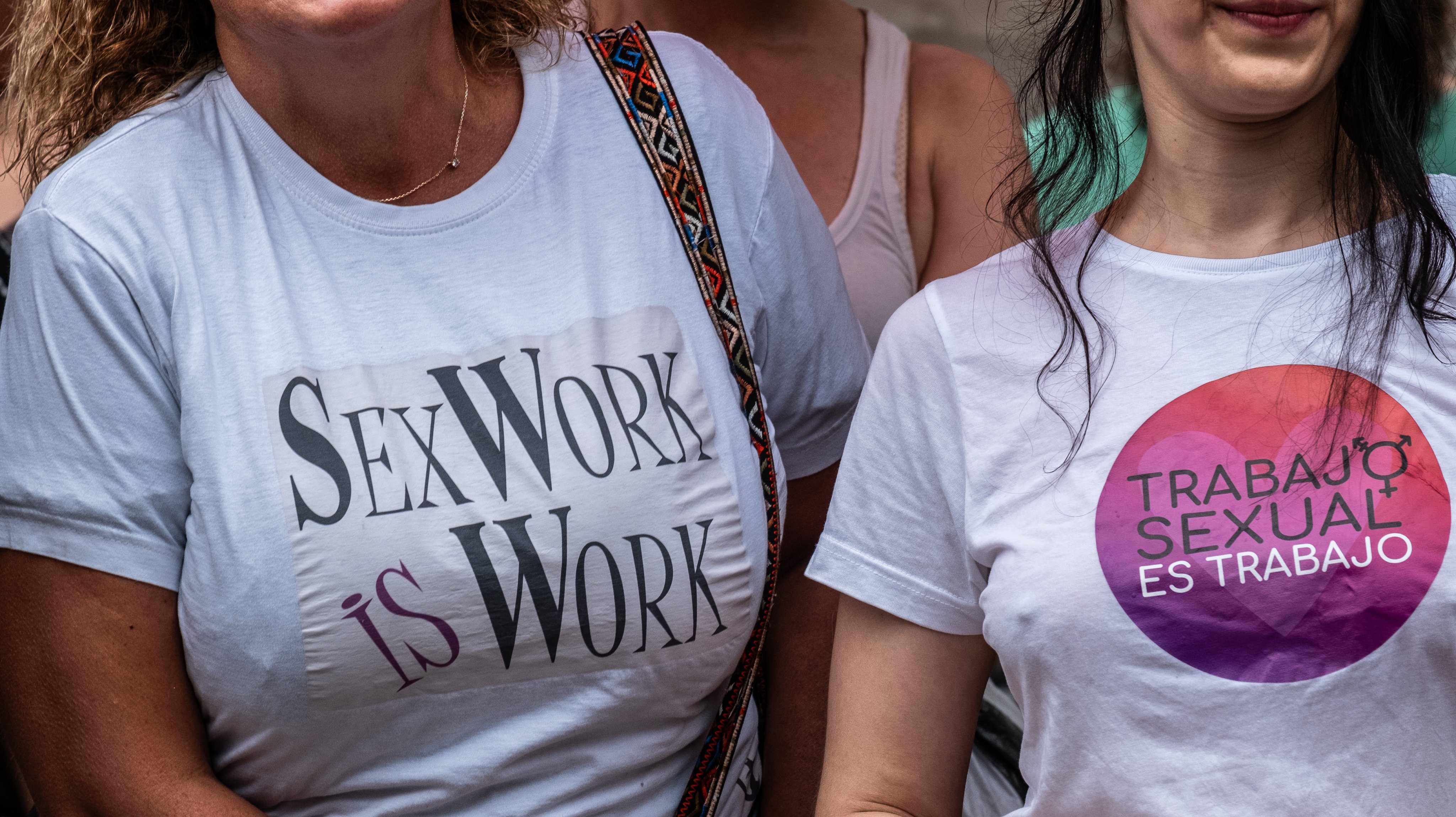 Two women wear shirts claiming the rights of sex workers.