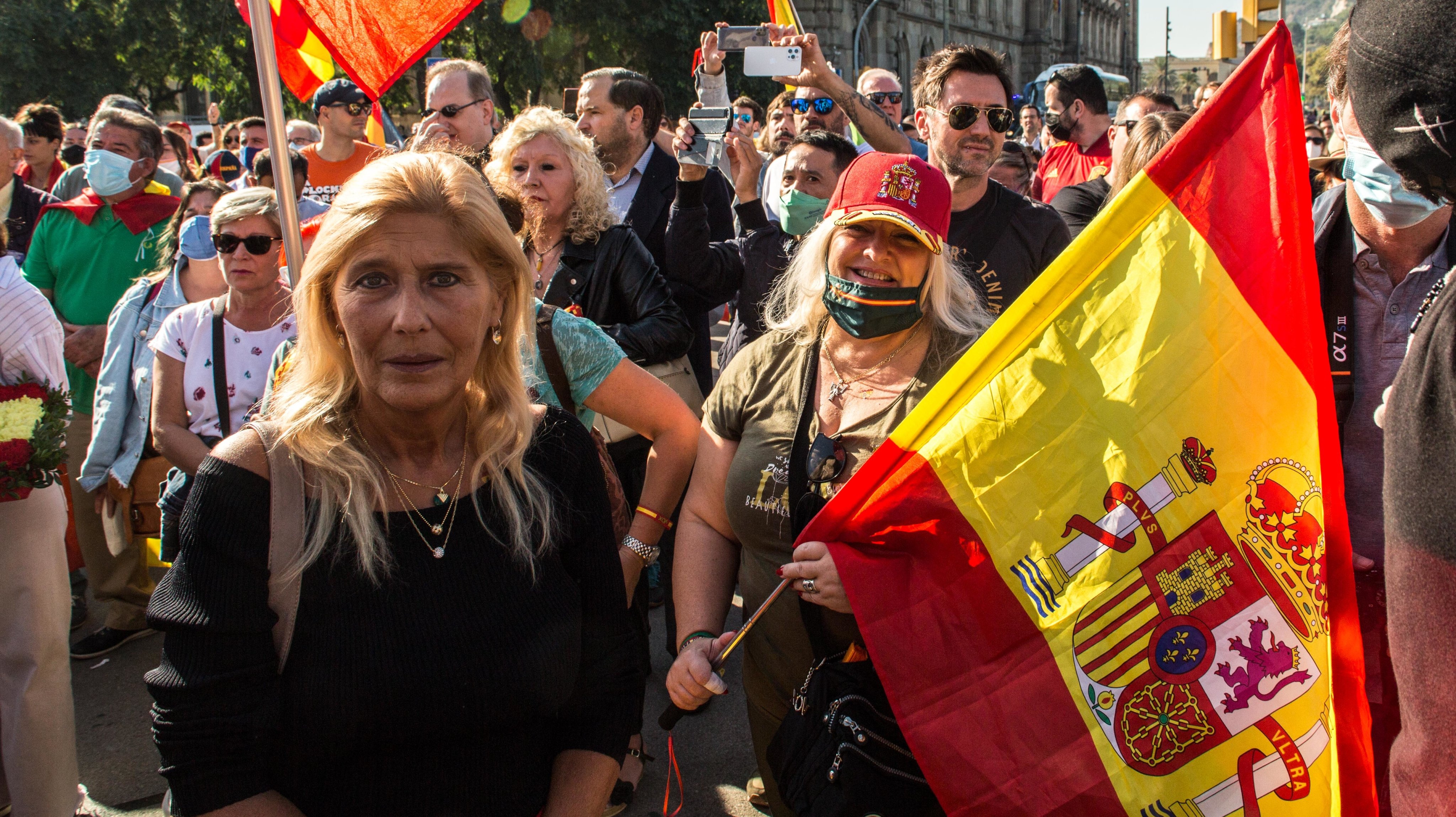 People are seen with Spanish flags in Floral Offering at the