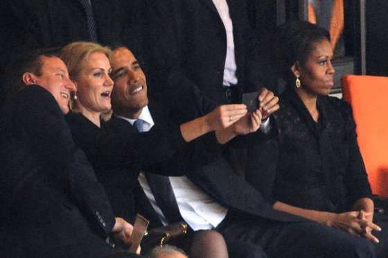 -- AFP PICTURES OF THE YEAR 2013 -- US President  Barack Obama (R) and British Prime Minister David Cameron pose for a selfie picture with Denmark's Prime Minister Helle Thorning Schmidt (C) next to US First Lady Michelle Obama (R) during the memorial service of South African former president Nelson Mandela at the FNB Stadium (Soccer City) in Johannesburg on December 10, 2013. Mandela, the revered icon of the anti-apartheid struggle in South Africa and one of the towering political figures of the 20th century, died in Johannesburg on December 5 at age 95.   AFP PHOTO / ROBERTO SCHMIDT        (Photo credit should read ROBERTO SCHMIDT/AFP/Getty Images)