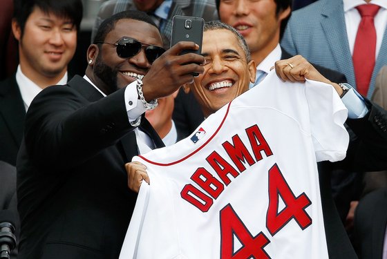 WASHINGTON, DC - APRIL 01:  Boston Red Sox designated hitter David Ortiz (L) poses for a "selfie" with U.S. President Barack Obama during a ceremony on the South Lawn of the White House to honor the 2013 World Series Champion Boston Red Sox April 1, 2014 in Washington, DC. The Red Sox defeated the St. Louis Cardinals in the 2013 World Series. (Photo by Win McNamee/Getty Images)