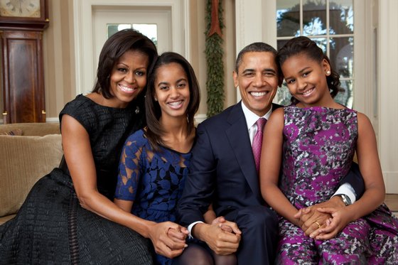 President Barack Obama, First Lady Michelle Obama, and daughters Sasha and Malia, pose for portrait photos in the Oval Office,  Dec. 11, 2001.  (Official White House Photo by Pete Souza)