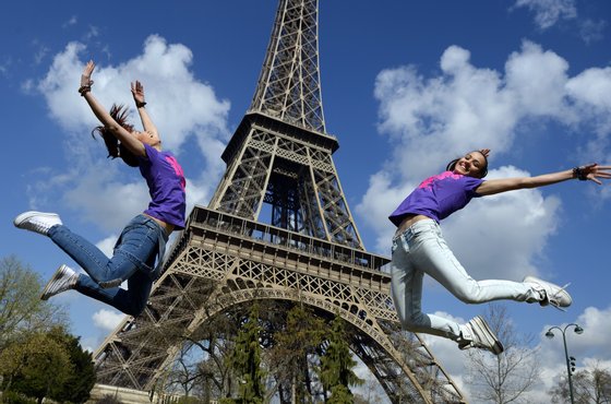 Two Bulgarian tourists pose in front of the Eiffel Tower in Paris on their last day in the capital on March 24, 2014. AFP PHOTO / FRANCK FIFE        (Photo credit should read FRANCK FIFE/AFP/Getty Images)