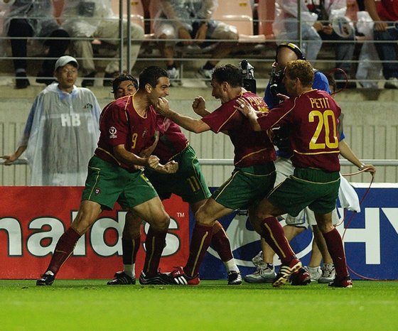 JEONJU - JUNE 10:  Pauletta of Portugal celebrates scoring the opening goal during the Group D match against Poland of the World Cup Group Stage played at the Jeonju World Cup Stadium, Jeonju, South Korea on June 10, 2002.  Portugal won the match 4-0. (Photo by Clive Brunskill/Getty Images)