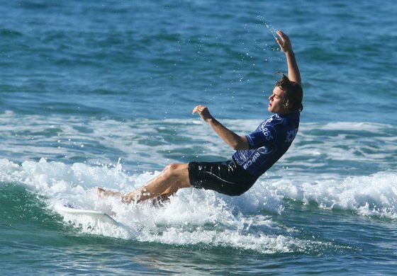 Williams Formula One team driver Nico Rosberg is given a surfing lesson by pro surfer Nathan Hedge at Bondi Beach on March 11, 2008 in Sydney, Australia, surf