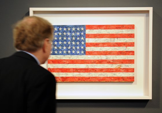 TO GO WITH AFP STORY US-LIFESTYLE ART by PAOLA MESSANA A man views Jasper Johns' "Flag", 1960-66, estimated at USD 10 million to 15 million, on display April 29, 2010 at Christie's in New York. This belongs to the collection of Michael Chrichton, to be sold at the Post-War and Contemporary art evening sale at Christie's May 11.  AFP PHOTO/Stan Honda (Photo credit should read STAN HONDA/AFP/Getty Images)