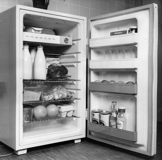 An open refrigerator full of food.   (Photo by Fox Photos/Getty Images)