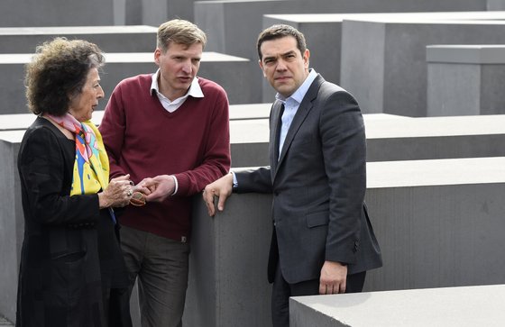Greek Prime Minister Alexis Tsipras (R) talks with German journalist Lea Rosh (L), who is at the origin of the Memorial to the Murdered Jews of Europe aka Holocaust Memorial during its visit in Berlin on March 24, 2015. Tspiras is making his first visit to the German capital since taking office in January 2015.   AFP PHOTO / TOBIAS SCHWARZ        (Photo credit should read TOBIAS SCHWARZ/AFP/Getty Images)