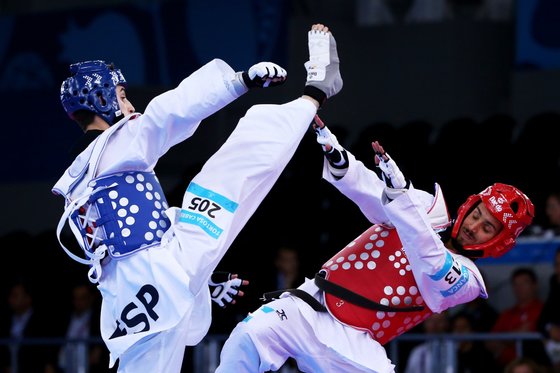 BAKU, AZERBAIJAN - JUNE 16:  Rui Braganca of Portugal (red) and Jesus Tortosa Cabrera of Spain compete in the Men's Taekwondo -58kg final during day four of the Baku 2015 European Games at Crystal Hall on June 16, 2015 in Baku, Azerbaijan.  (Photo by Tom Pennington/Getty Images for BEGOC)
