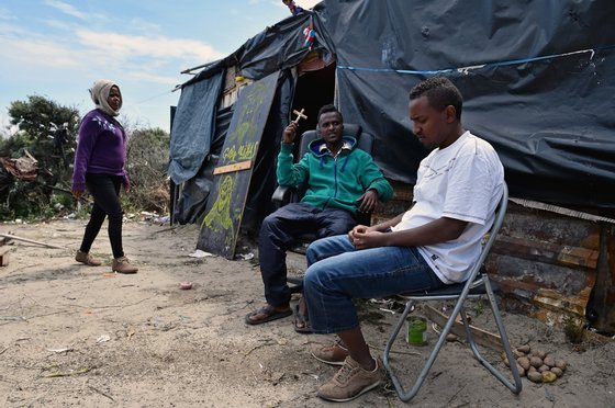 CALAIS, FRANCE - JUNE 25:  Migrants are seen in a make shift camp known as the 'New Jungle' on June 25, 2015 in Calais, France. Many migrants are camped in Calais on the side of the motorways as they attempt to board trucks stuck in slow moving traffic in the hope of making it into the UK.  (Photo by Jeff J Mitchell/Getty Images)