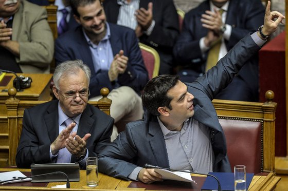 Greek Prime Minister Alexis Tsipras (R) gestures at a joint session of four committees of the Parliament (Economic, Social, Public Administration and Production and Trade) at the Greek Parliament in Athens on July 10, 2015. Lawmakers in Greece are to vote whether to back a last-ditch reform plan the government submitted to creditors overnight in a bid to stave off financial collapse and exit from the Eurozone. Greece's international creditors believe its latest debt proposals are positive enough to be the basis for a new bailout worth 74 billion euros, an EU source said June 10. AFP PHOTO/ANDREAS SOLARO        (Photo credit should read ANDREAS SOLARO/AFP/Getty Images)