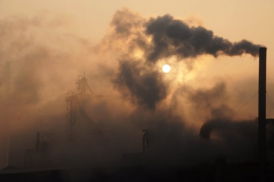 This picture taken on January 17, 2013 shows a cement factory releasing heavy smoke in Binzhou, in eastern China's Shandong province. China's economy grew at its slowest pace in 13 years in 2012, the government said on January 18, but an uptick in the final quarter pointed to better news ahead for a prime driver of the tepid global recovery.  CHINA OUT     AFP PHOTO        (Photo credit should read STR/AFP/Getty Images)