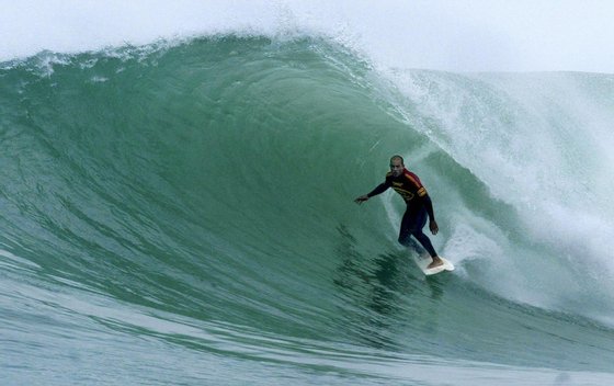 Kelly Slater of the US rides a wave in round three of the Billabong Pro at Jeffreys Bay in South Africa, 20 July 2003. Slater dominated his heat against Lee Winkler of Australia posting a near perfect 19.50 (out of 20 points) heat tally, the highest of the event to date and his best single heat score of the year, to advance to round four.   AFP PHOTO/Grant ELLIS/Tostee.com/HO  (Photo credit should read GRANT ELLIS/AFP/Getty Images)