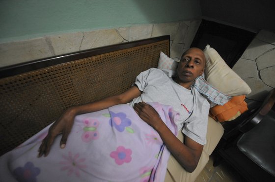 Cuban opposition activist Guillermo Farinas lies on a couch at his home in Santa Clara, Cuba, March 10, 2010. Farina, who has been in hunger strike for two weeks, said that he is ready to die if President Raul Castro doesn't release 26 seriously ill political prisoners. AFP PHOTO/ADALBERTO ROQUE (Photo credit should read ADALBERTO ROQUE/AFP/Getty Images)
