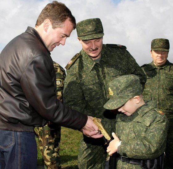 Russian President Dmitry Medvedev (L) and his Belarussian counterpart Alexander Lukashenko (C) interact with Lukashenko's five-year-old son Nikolay at the Obuz-Lesnovsky firing range near Baranovichi on September 29, 2009 while observing the joint Russian-Belarussian military exercises "West-2009". The exercises involve more than 12,000 troops, over 200 tanks, 470 armored vehicles, and more than 100 aircraft. AFP PHOTO / RIA NOVOSTI / KREMLIN POOL / VLADIMIR RODIONOV (Photo credit should read VLADIMIR RODIONOV/AFP/Getty Images)