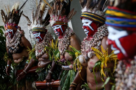 PORT MORESBY, PAPUA NEW GUINEA - MAY 10: Traditional dancers perform ahead of the arrival of Australian Prime Minister Julia Gillard and Papua New Guinea Prime Minister Peter O'Neill at Parliament House on May 10, 2013 in Port Moresby, Papua New Guinea. The three-day visit is a chance for the two nations to strengthen economic ties, with talks being held on key issues including, trade, military defense, and the controversial Australian detention center on Manus Island.The trip is the first official visit for Prime Minister Julia Gillard to the Pacific Island Nation and the first visit since former prime minster Kevin Rudd visited in 2007. (Photo by Chris McGrath/Getty Images)