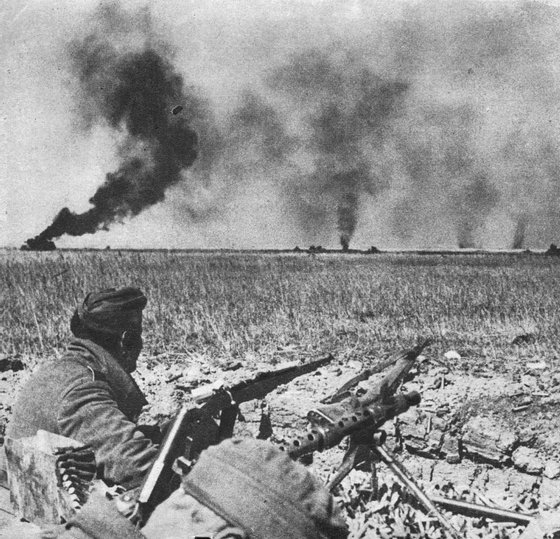 circa 1942: A Nazi soldier in his front-line post watching the burning Soviet and German Panzer tanks. (Photo by Keystone/Getty Images)