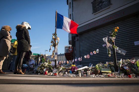 People stand at a makeshift memorial for a tribute to the victims of a series of deadly attacks in Paris, in front of the Le Petit Cambodge restaurant in Paris on November 23, 2015. Gunmen and suicide bombers went on a killing spree in Paris on November 13, attacking the concert hall Bataclan as well as bars, restaurants and the Stade de France. Islamic State jihadists operating out of Iraq and Syria released a statement claiming responsibility for the coordinated attacks that killed 130 and injured over 350. AFP PHOTO / LIONEL BONAVENTURE / AFP / LIONEL BONAVENTURE (Photo credit should read LIONEL BONAVENTURE/AFP/Getty Images)