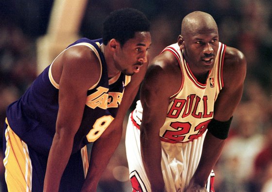 CHICAGO, UNITED STATES: Los Angeles Lakers guard Kobe Bryant(L) and Chicago Bulls guard Michael Jordan(R) talk during a free-throw attempt during the fourth quarter 17 December at the United Center in Chicago. Bryant, who is 19 and bypassed college basketball to play in the NBA, scored a team-high 33 points off the bench, and Jordan scored a team-high 36 points. The Bulls defeated the Lakers 104-83. AFP PHOTO VINCENT LAFORET (Photo credit should read VINCENT LAFORET/AFP/Getty Images)