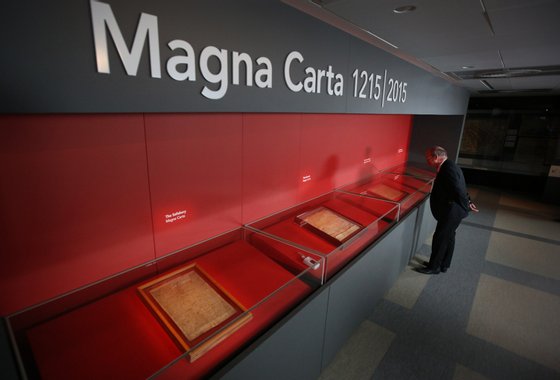 LONDON, ENGLAND - FEBRUARY 02: A visitor looks at one of the four copies of the Magna Carta on display at the British Library on February 2, 2015 in London, England. Magna Carta, one of the world's most influential documents, is an agreement granted by King John in 1215 as a practical solution to a political crisis, which in the centuries since has become a potent symbol of liberty and the rule of law. The British Library, Lincoln Cathedral and Salisbury Cathedral have brought those four original surviving Magna Carta manuscripts together in one place, for the first time as part of a year of international celebrations to mark the 800th anniversary of the issue of the Charter by King John in 1215. (Photo by Peter Macdiarmid/Getty Images)