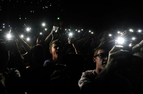 LAS VEGAS, NV - MAY 02: Fans hold up phones with lights as actor/comedian Donald Glover as recording artist Childish Gambino performs at The Chelsea at The Cosmopolitan of Las Vegas during his Deep Web tour in support of the album "because the internet" on May 2, 2014 in Las Vegas, Nevada. (Photo by Ethan Miller/Getty Images)