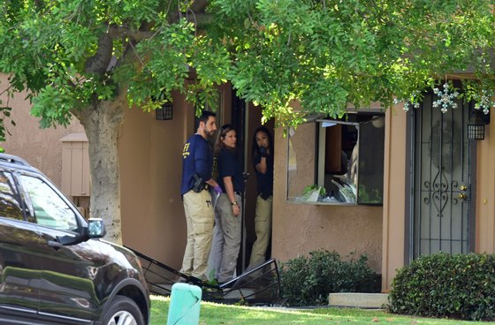 FBI agents investigate at a townhome in Redlands, California December 3, 2015, which is linked to the December 2 shooting rampage in San Bernardino, California. At least 14 people were killed in a gun attack on a holiday party in the country's worst mass shooting since the massacre of 26 people at Sandy Hook elementary school in Connecticut in 2012. A heavily armed man and woman killed at least 14 people and injured at least 17 at a social services center in San Bernardino before the suspects died during a shootout with police. AFP PHOTO /ROBYN BECK / AFP / ROBYN BECK (Photo credit should read ROBYN BECK/AFP/Getty Images)