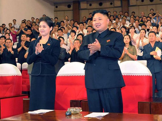 (FILES) This file picture taken on July 6, 2012 by North Korean official Korean Central News Agency and released on July 9 shows North Korean leader Kim Jong Un (C), accompanied by a young woman (L), enjoying a demonstration performance given by the newly organized Moranbong band in Pyongyang. North Korean state television on July 25, 2012 confirmed that leader Kim Jong-Un is married and named his wife as Ri Sol-Ju, South Korea's unification ministry said. South Korea's unification ministry said it appeared that Ri was the woman who has been pictured several times at Kim's side at public events in recent weeks. AFP PHOTO / KCNA via KNS / FILES ---EDITORS NOTE--- RESTRICTED TO EDITORIAL USE - MANDATORY CREDIT "AFP PHOTO / KCNA VIA KNS" - NO MARKETING NO ADVERTISING CAMPAIGNS - DISTRIBUTED AS A SERVICE TO CLIENTS (Photo credit should read KNS/AFP/GettyImages)